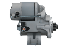 side view of A new Kubota starter motor with a 1.4 kW power rating, showing a metallic body with electrical connectors and a label.