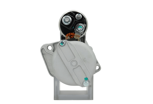 back view of A new 12V starter Renault 1.7 kw, with visible metal and electrical components and 9 teeth, against a white background.