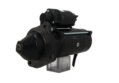 A black starter motor for a vehicle, with visible mounting points and electrical connectors.